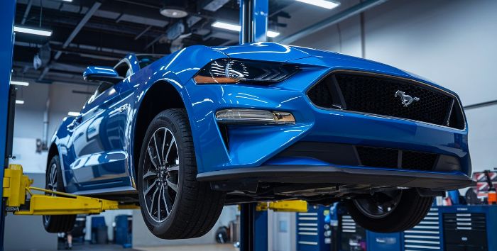 Allard Collision Repair Chandler – Blue Ford Mustang on Lift Allard Collision Repair Chandler - Blue Ford Mustang on Lift