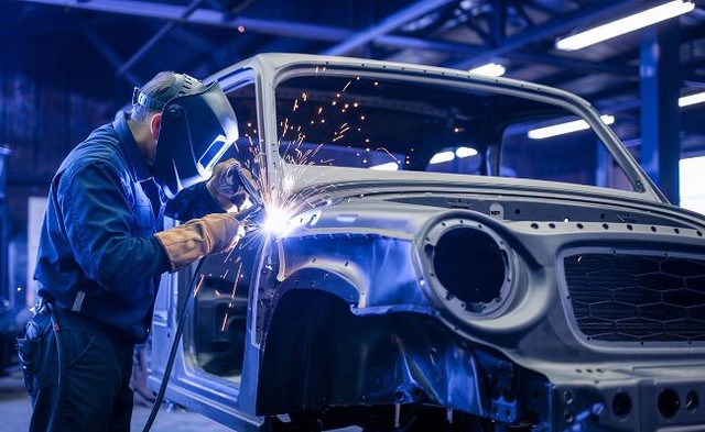 Auto Body Technician Working on vehicle collision repair process tech welding